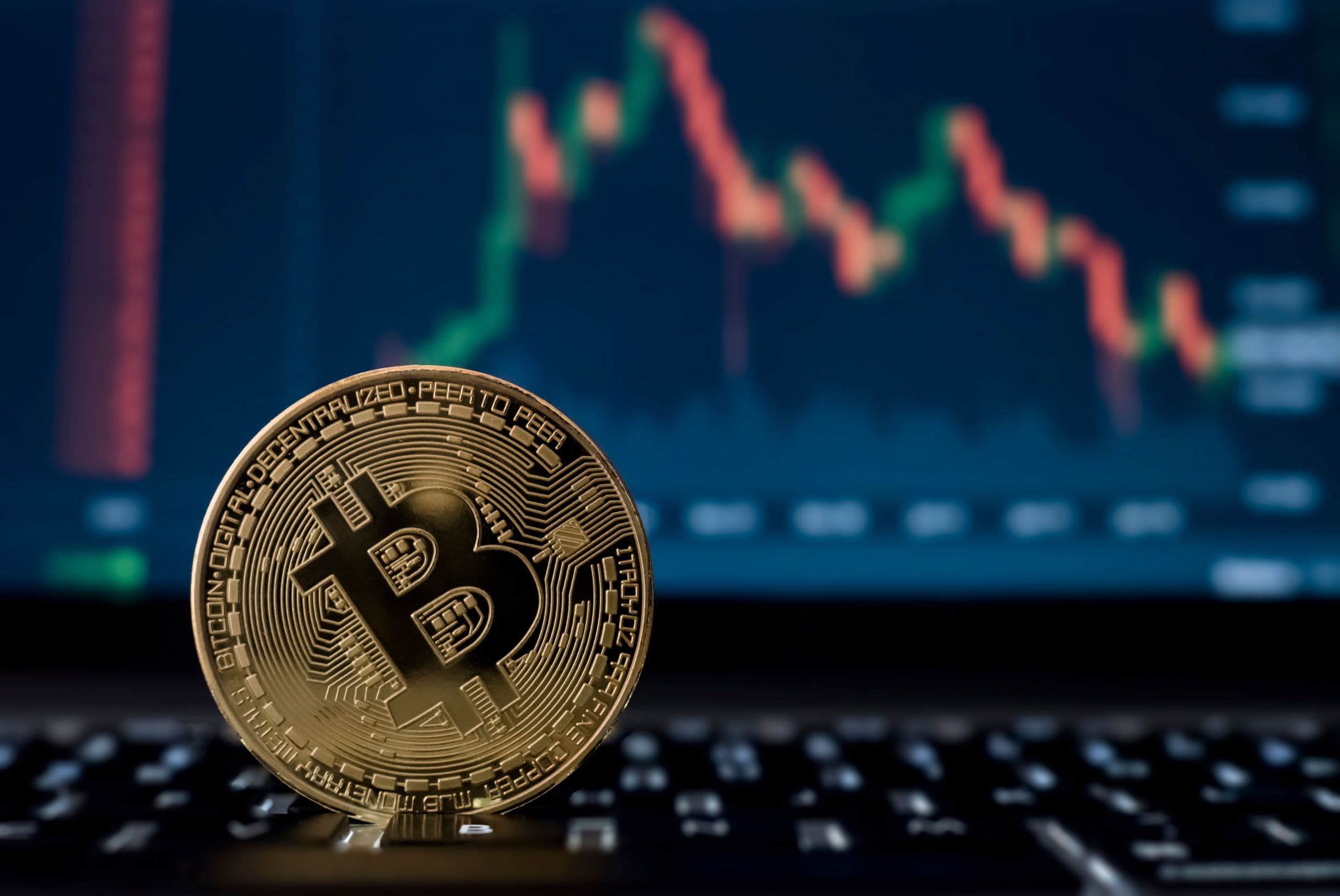 106893887 1623167512779 bitcoin digital crypto currency with stock market candlesticks on computer screen